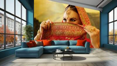 Portrait smiling of beautiful indian girl at home. Young woman model with golden jewelry set . Wall mural