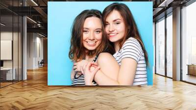 two pretty teen girlfriends smiling hugs and having fun Wall mural