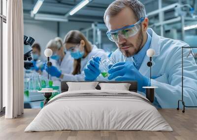 A scientist in a lab coat carefully examines green liquid in test tubes, focused on experimentation. Wall mural