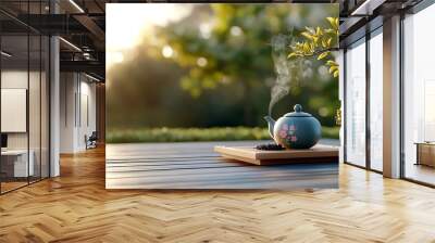 A teapot sends gentle steam into the air, resting on a wooden table in a tranquil garden setting. Wall mural