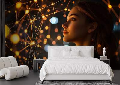 A woman looks up at an abstract network of golden lights, captivated by the web of connections. Wall mural