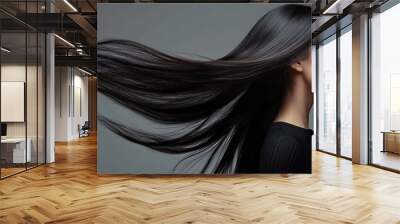 Beautiful asian coasian woman with long hair posing in studio on grey background. Women Hair Is Fluttering In The Wind Wall mural