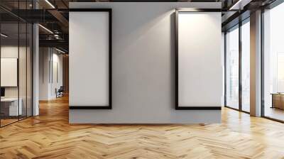 In a contemporary architectural studio, two white frames with dark borders are displayed against a light gray wall. Wall mural