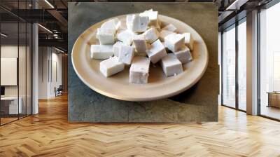 fresh cheese slice put in a plate isolated on stone background Wall mural