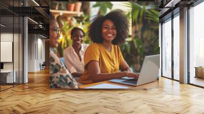 Group of African American employees or small business owner start-up looking camera working meeting sitting in workplace room, creative workers using technology laptop computer, teamwork entrepreneur Wall mural