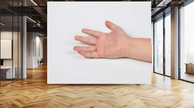 Selective focus hand of little Asian boy and fingers symbols in one two victory thum up and begging on white isolated background Wall mural