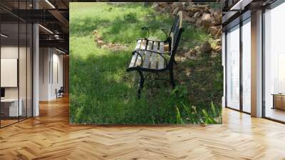 Steel and wooden bench at a park, side view Wall mural