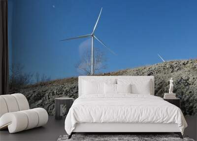 Upward shot of a windmill installed on a hilltop Wall mural