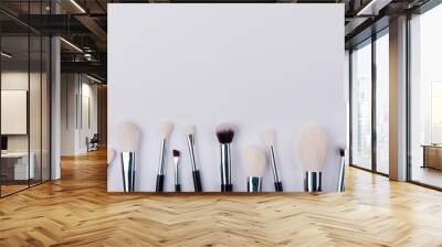 Make up brush lie on white background background Wall mural