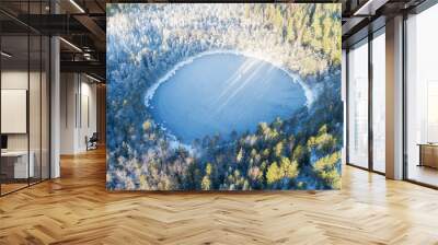 Frozen lake and winter forest. Christmas nature. Rime ice and hoar frost covering trees. Beautiful aerial view of ice covered lake. Wall mural