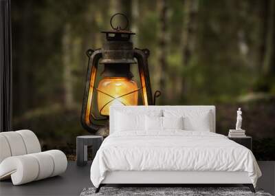 Vintage old lantern lighting in the dark forest. Travel camping concept. Burning lantern on a moss at forest in the night. Wall mural