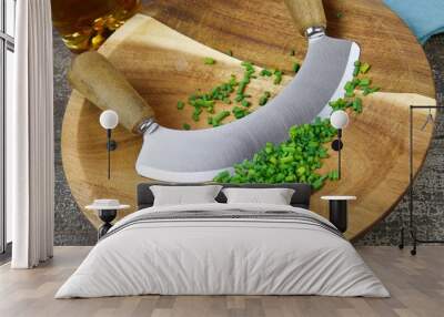 Preparation of herbs for meal: isolated brown wood cutting board with chef´s mincing knife, chopped green chives Wall mural