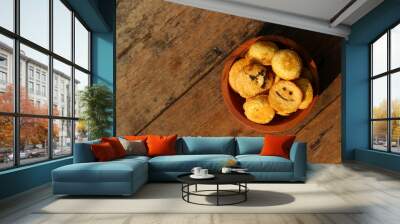 Kue bolu kering or Dried sponge cake in a small wooden bowl with wooden background Wall mural