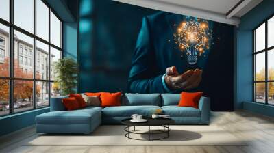 businessman holding light bulb with idea Wall mural