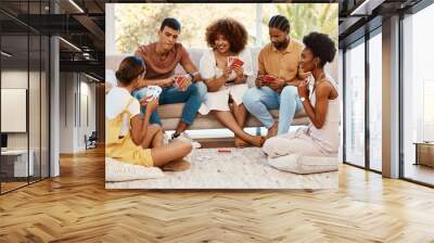 Game, smile or friends playing cards, poker or black jack at home for gambling together in a holiday party. Happy, men or group of women laughing to relax in living room in a fun match competition Wall mural