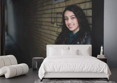 Beautiful curly Bosnian Caucasian woman in a black leather jacket under the tunnel Wall mural