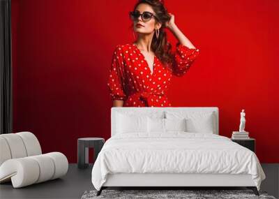 Stylish Indian woman in summer fashion trend dotted red dress posing on red generative ai Wall mural