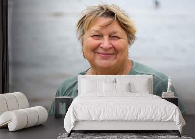 Mature plump woman resting on the beach of the sea Wall mural