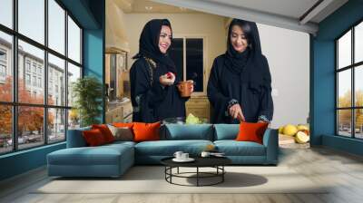 Two Arabian Women Cooking & Drinking coffee in the Kitchen Wall mural