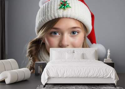 Girl wearing a woolen hat in winter with Christmas ornaments Wall mural