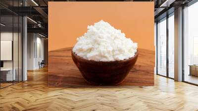 Freshly Churned White Butter Also Known As Safed Makhan Malai Or Homemade Makkhan In India Is Used To Prepare Desi Ghee In Wooden Bowl. Isolated On Beige Color Background With Copy Space For Text Wall mural