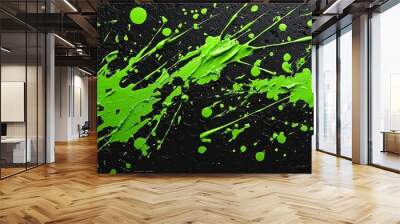 A vibrant splash of green paint on a textured black background, showcasing an abstract artistic expression. Wall mural