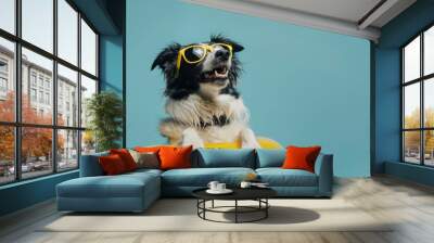 dog wearing sunglasses with a swim ring with a blue background. summer vacation concept banner for web design Wall mural