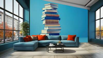 stack of books on blue background with copy space, banner design Wall mural