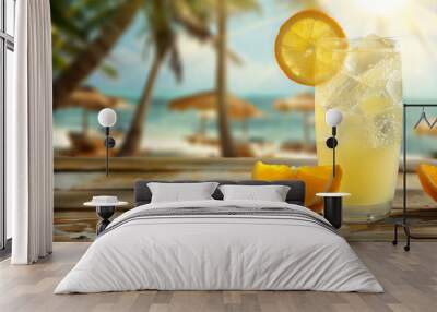 yellow cocktail with ice and a slice of orange on a wooden table against a beach background Wall mural