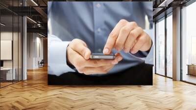 close up of a man using smartphone Wall mural