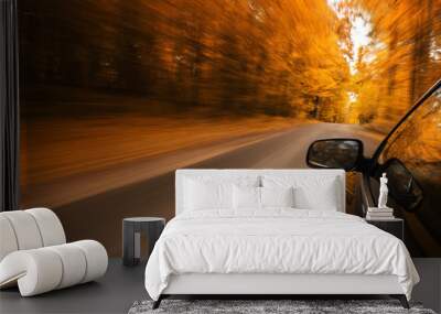 Close up of a sport car speeding on the empty, autumn road with copy space Wall mural