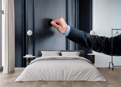 Close up of young man knocking on the door Wall mural