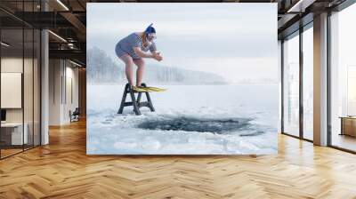 fuunny overweight, retro swimmer about to jump into ice hole in the lake, with copy space Wall mural