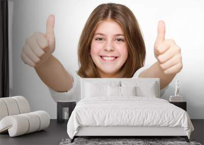 Little girl showing two thumbs up isolated on white background Wall mural