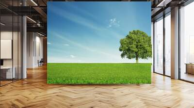 Lonely tree at the empty green field with copy space Wall mural