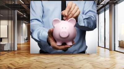 male hand putting coin into a piggy bank Wall mural