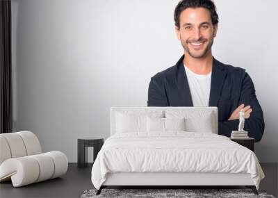 Portrait of happy handsome Hispanic businessman smiling with arms crossed Wall mural