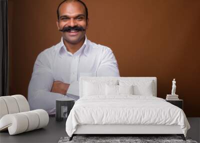 Portrait of happy Indian businessman with mustache in casual clothing Wall mural