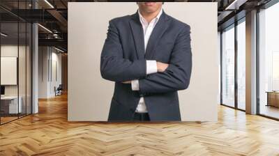 Portrait of young Filipino businessman in suit with arms crossed Wall mural