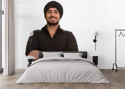 Portrait of young happy Indian Sikh man smiling Wall mural