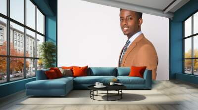 Profile view of young happy African businessman smiling and looking at camera Wall mural