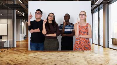 Studio shot of diverse group of multi ethnic friends thinking wh Wall mural