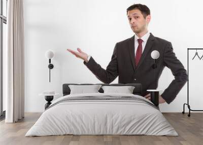 Studio shot of young businessman showing something Wall mural