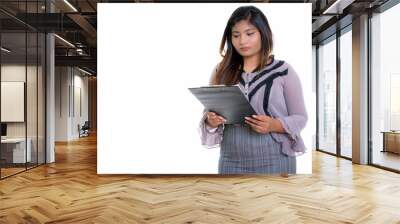 Studio shot of young fat Persian businesswoman reading on clipbo Wall mural