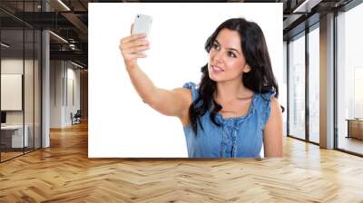 Studio shot of young happy Spanish woman smiling while taking se Wall mural