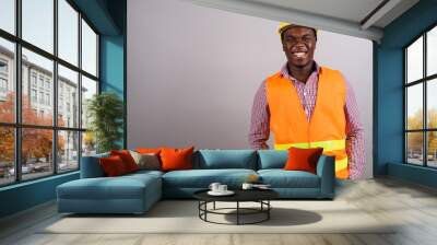 Young African man construction worker against white background Wall mural