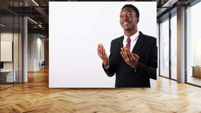 Young handsome African businessman wearing suit against white ba Wall mural