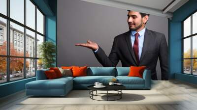 Young handsome bearded Persian businessman against gray backgrou Wall mural