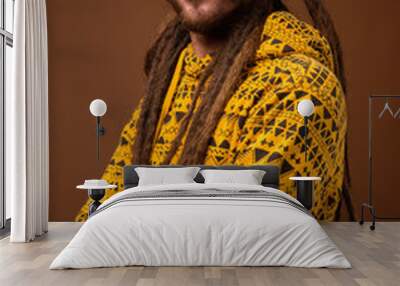 Young handsome Hispanic man with dreadlocks against brown backgr Wall mural