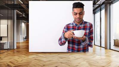 Young Indian man wearing checkered shirt against white backgroun Wall mural